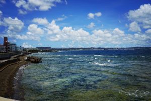 Waves from the ocean crashing against the Sunabe Sea Wall fall in Okinawa