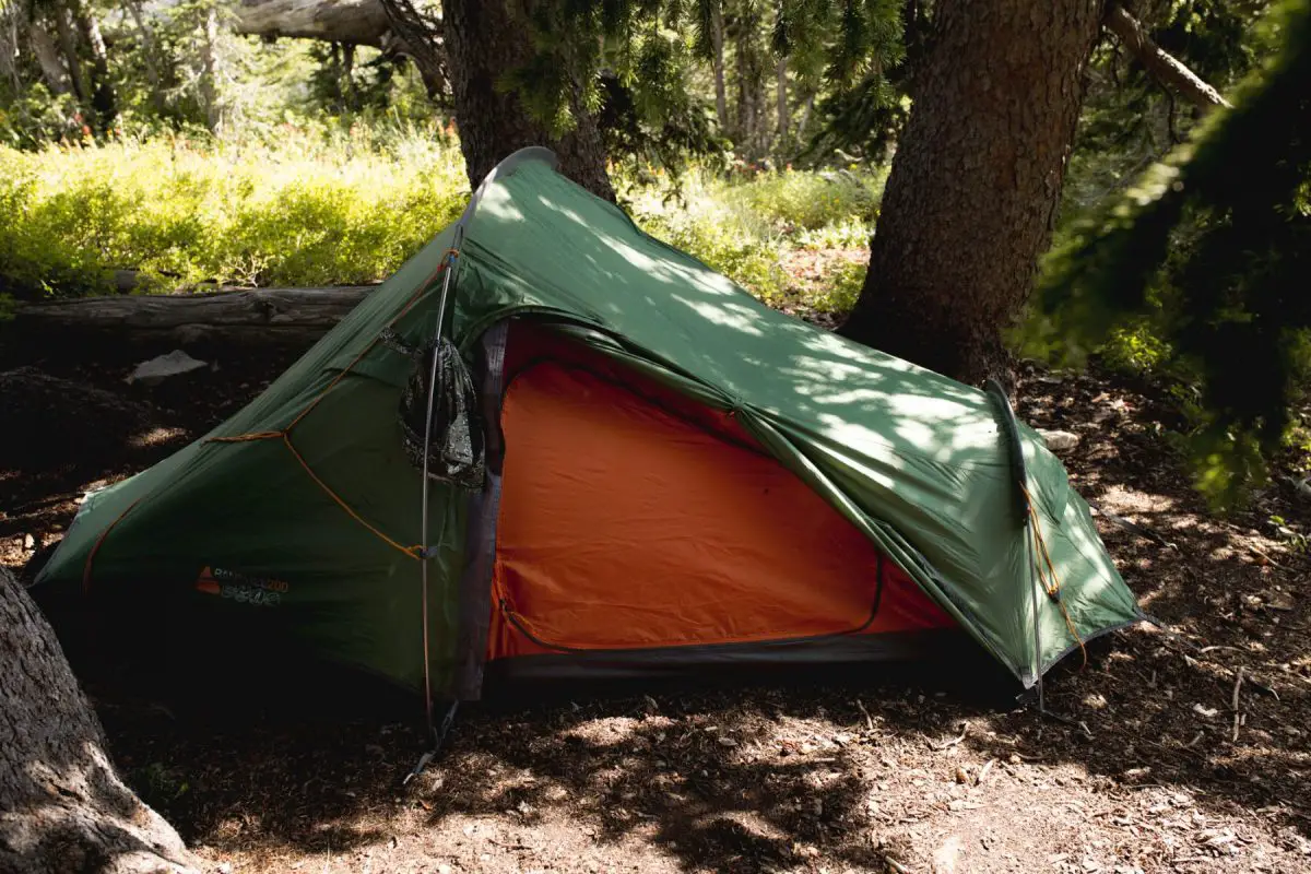 green tent pitched in proper campsite - beginner backppacking mistake 3