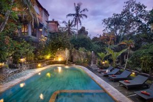 A private pool surrounded by lush jungle and comfortable chairs at Ketuts Place, a top choice for people wondering where to stay in Ubud.